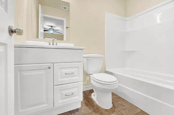 a bathroom with a sink toilet and vanity