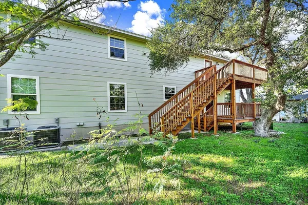 a view of a house with a yard and sitting area