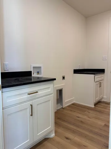 a view of washer and dryer with wooden floor