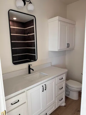 a kitchen with a sink and a toilet