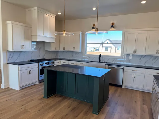 a kitchen with a sink a window and cabinets