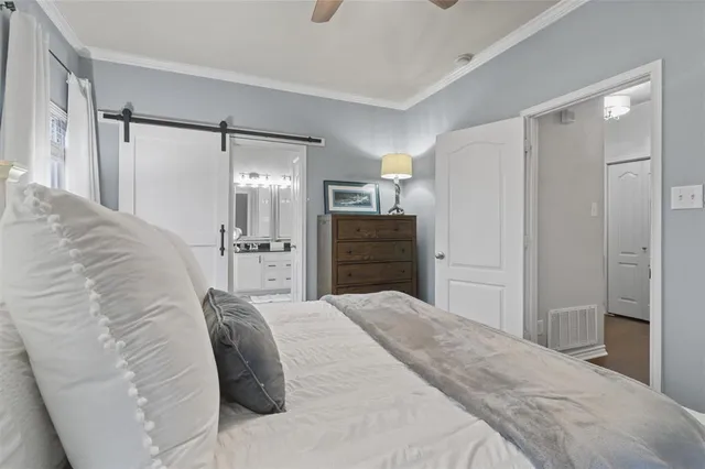 a spacious bedroom with a bed and cabinet