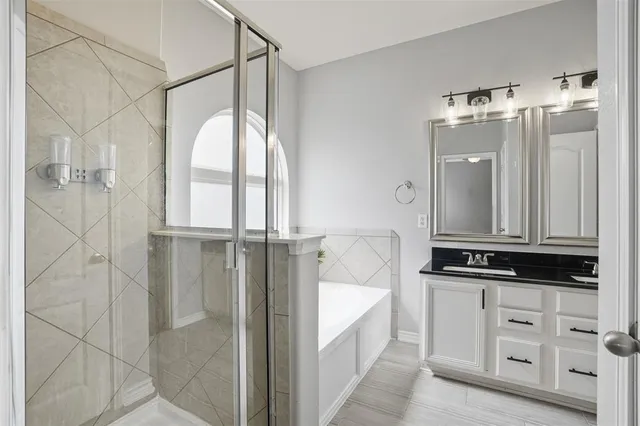 a bathroom with a double vanity sink and mirror