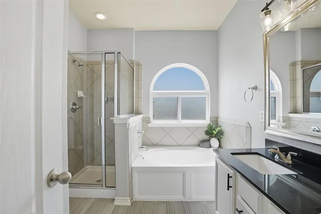 a bathroom with a granite countertop sink mirror and shower