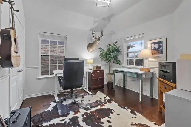 a living room with furniture a wooden floor and next to a window