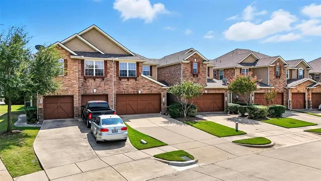 a front view of a house with a garden and plants