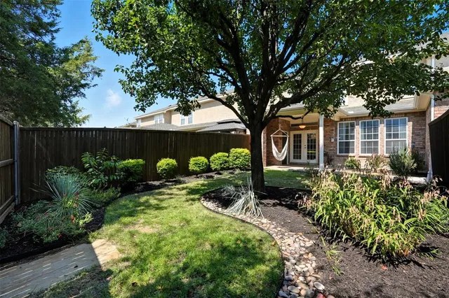 a front view of a house with garden and plants