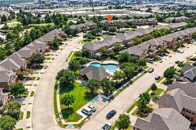 an aerial view of residential houses with outdoor space