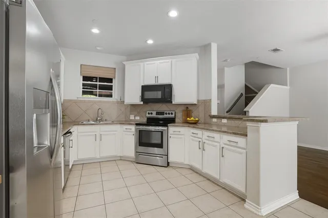 a kitchen with a sink stove and refrigerator
