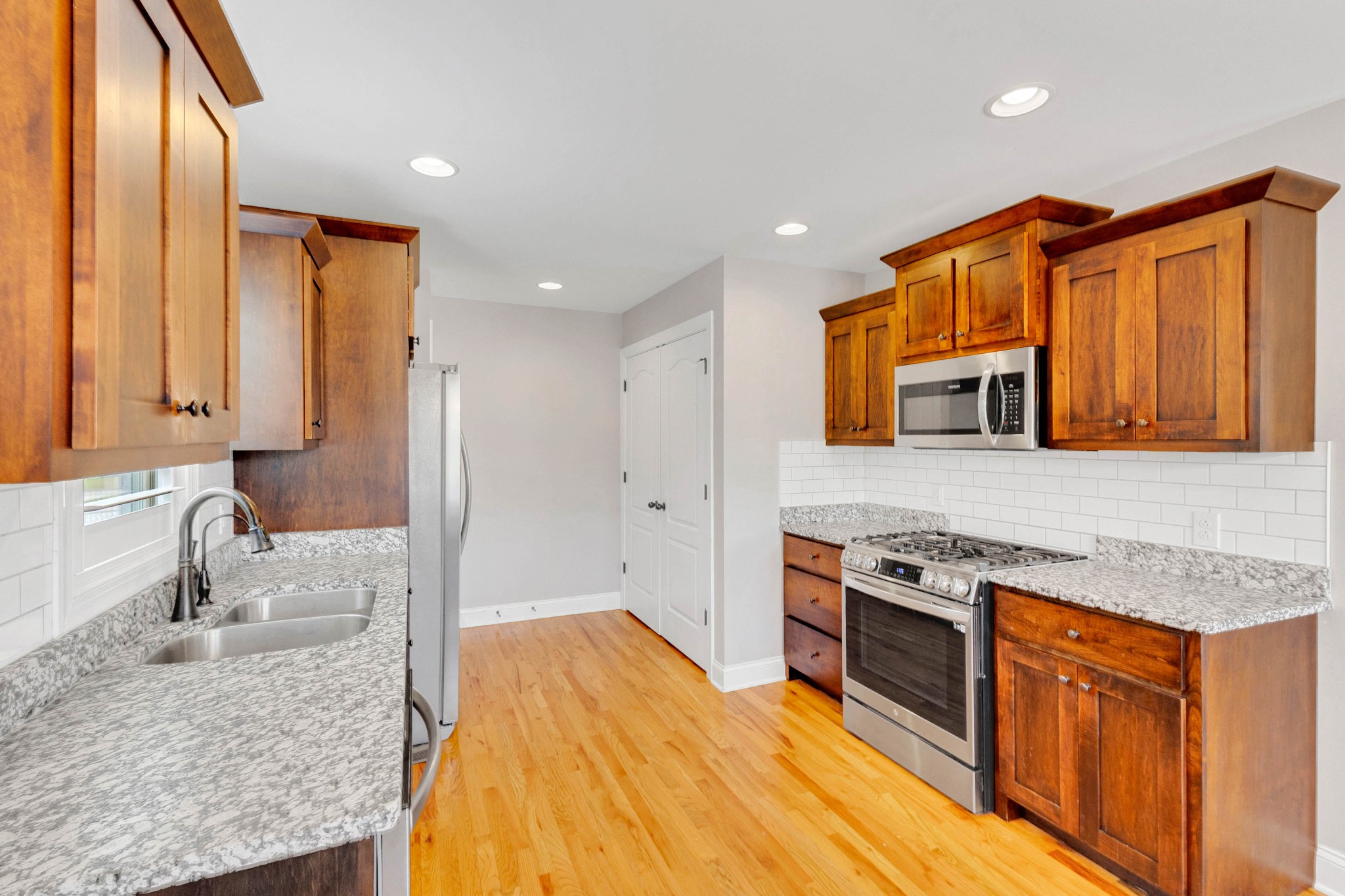 509 Gunn Lane Springfield, TN 37172 - Photo 16 of 48 a kitchen with stainless steel appliances granite countertop a sink stove and refrigerator