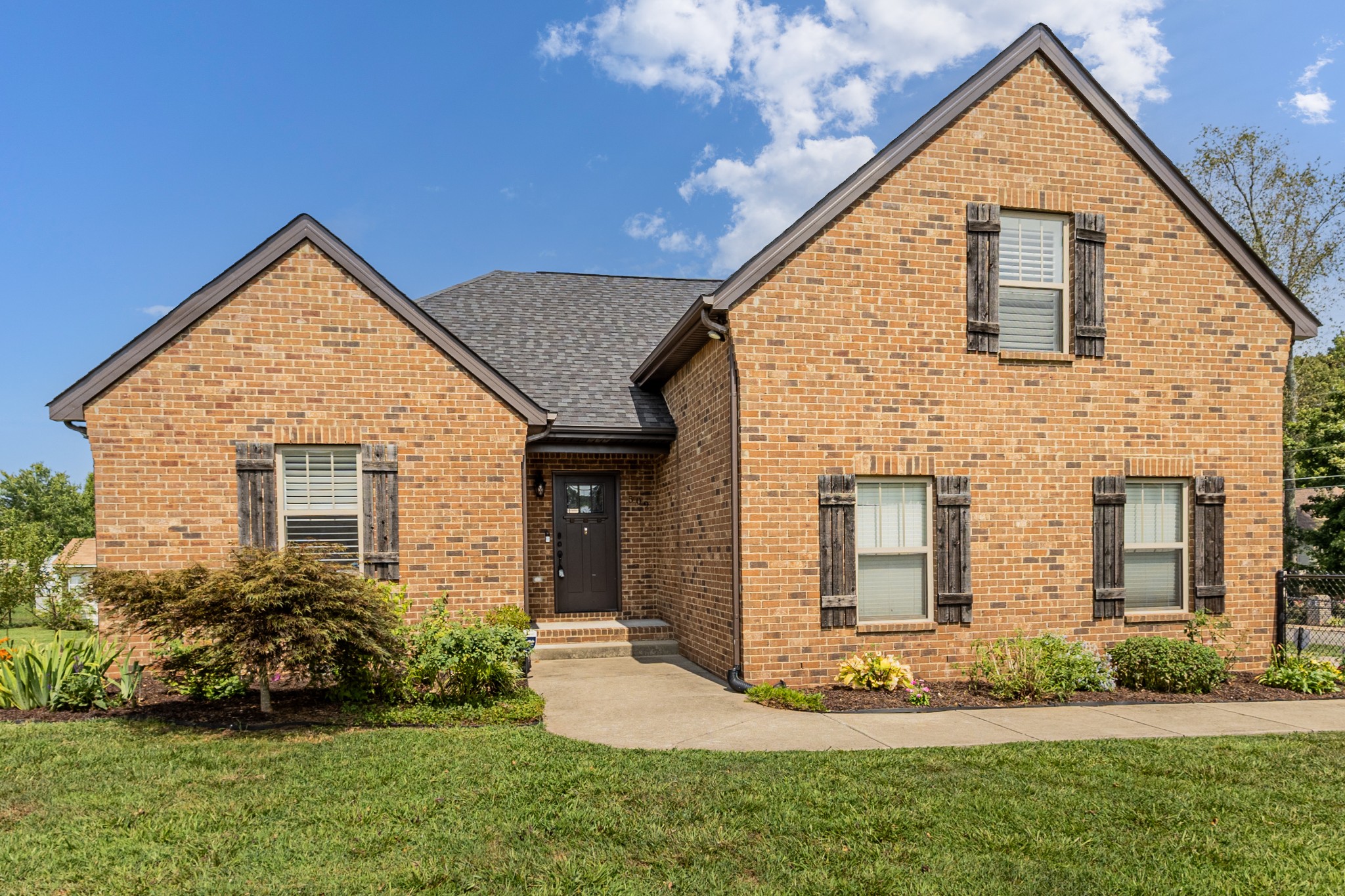 509 Gunn Lane Springfield, TN 37172 - Photo 2 of 48 a view of a house with brick walls and a yard with plants