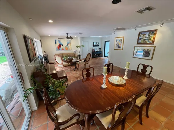 a living room with furniture a flat screen tv and a floor to ceiling window