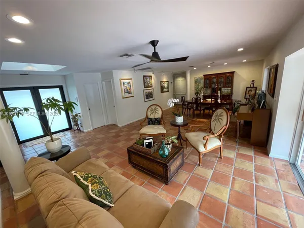 a kitchen with kitchen island granite countertop a sink a counter top space cabinets and stainless steel appliances