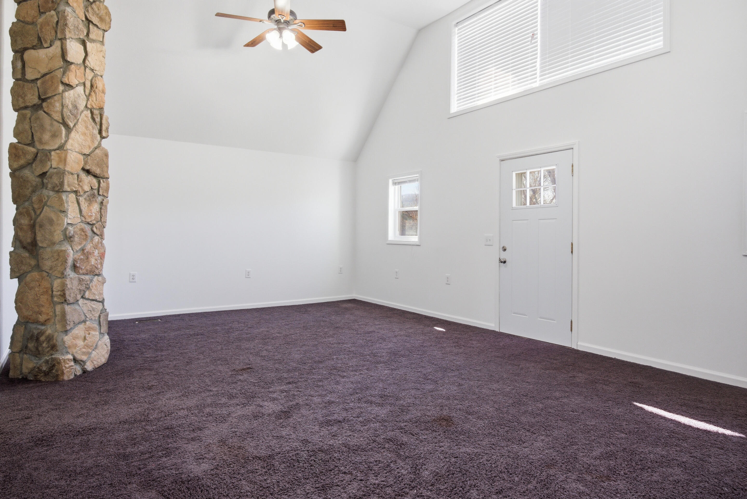 6458 Piney Woods Road Riner, VA 24149 - Photo 24 of 50 an empty room with a ceiling fan and a window
