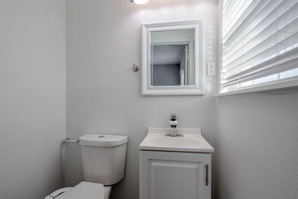 2824 Lockhart Avenue Dallas, TX 75228 - Photo 11 of 16 a bathroom with a sink and a toilet