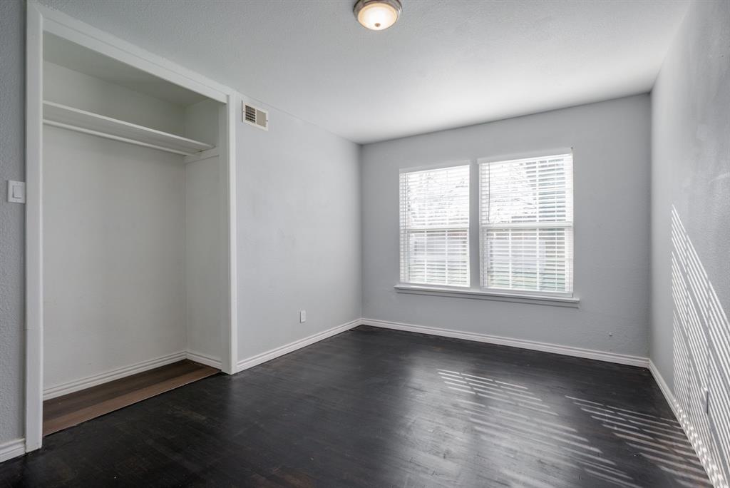 2824 Lockhart Avenue Dallas, TX 75228 - Photo 12 of 16 an empty room with wooden floor and windows