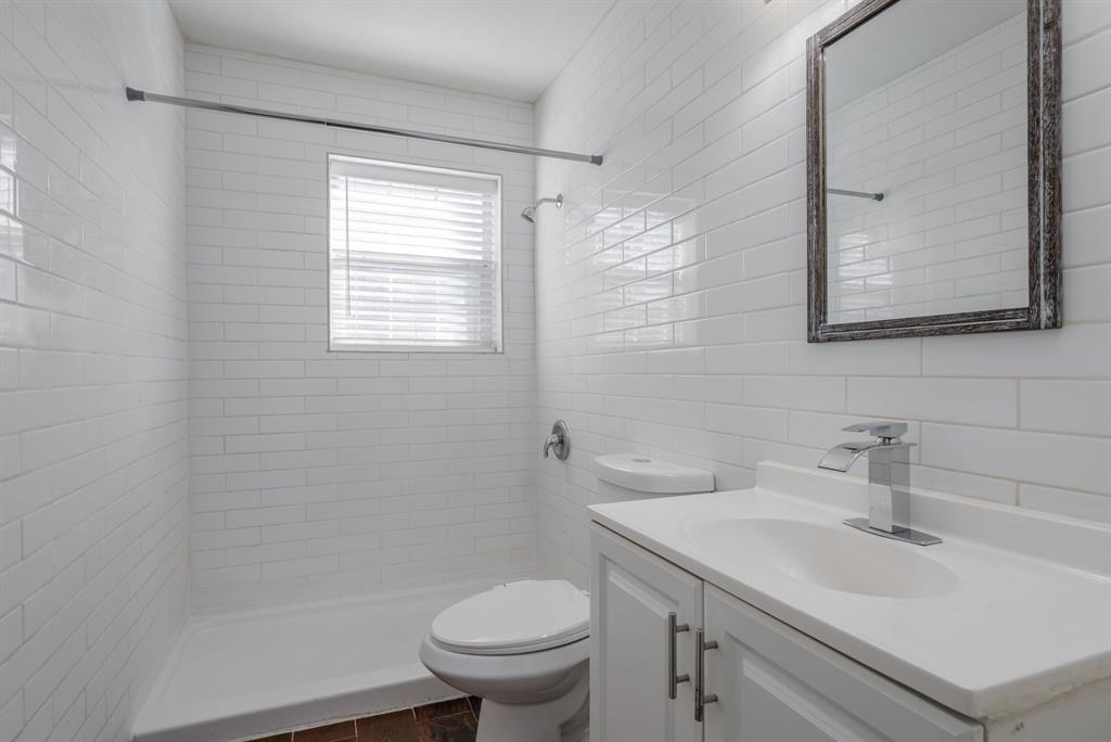 2824 Lockhart Avenue Dallas, TX 75228 - Photo 13 of 16 a bathroom with a sink toilet and vanity