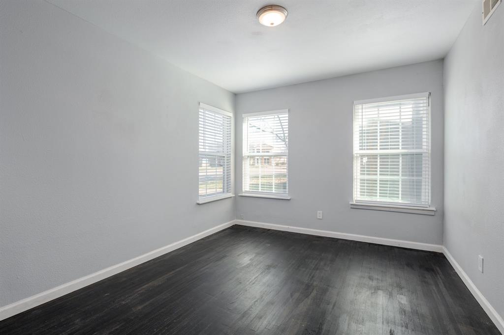 2824 Lockhart Avenue Dallas, TX 75228 - Photo 14 of 16 an empty room with wooden floor and windows