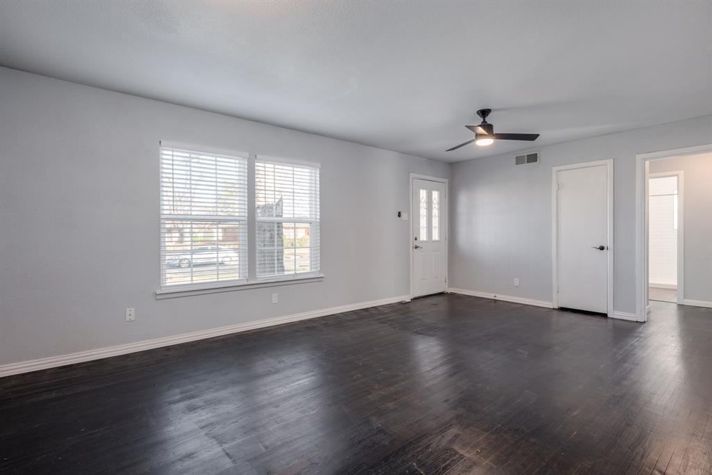 2824 Lockhart Avenue Dallas, TX 75228 - Photo 5 of 16 an empty room with wooden floor and windows