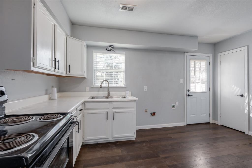 2824 Lockhart Avenue Dallas, TX 75228 - Photo 7 of 16 a kitchen with granite countertop a stove and a sink