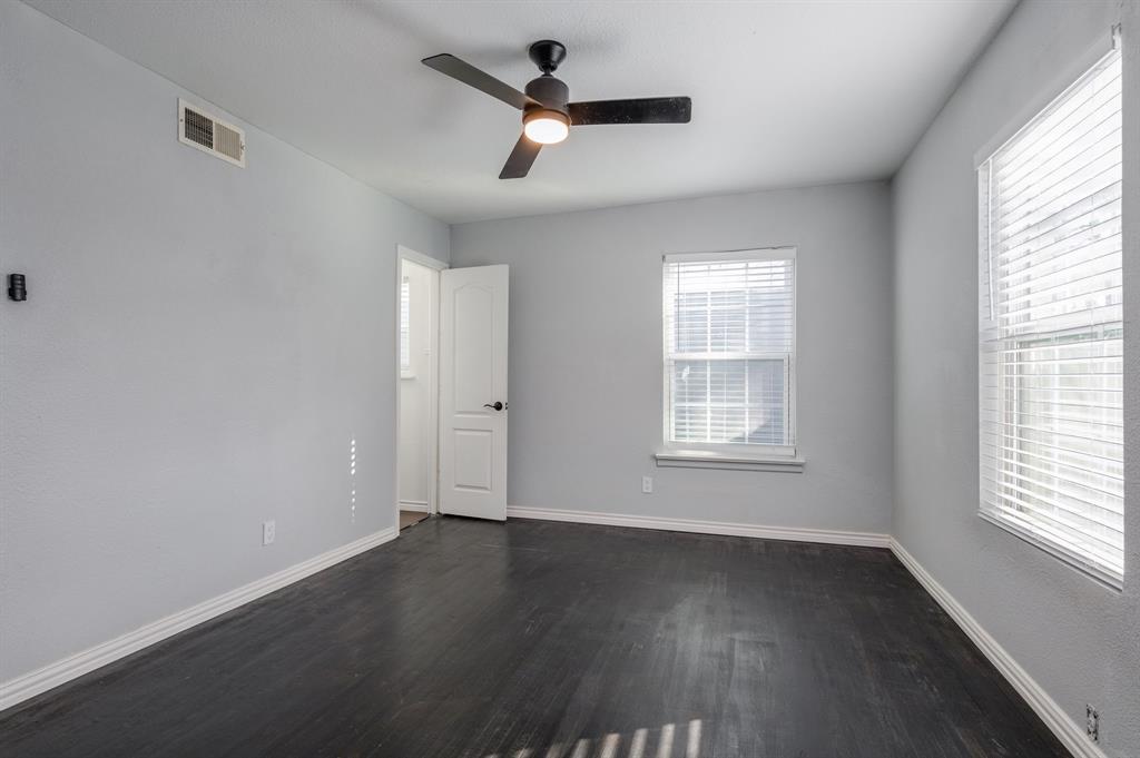 2824 Lockhart Avenue Dallas, TX 75228 - Photo 10 of 16 a view of an empty room with wooden floor and a window