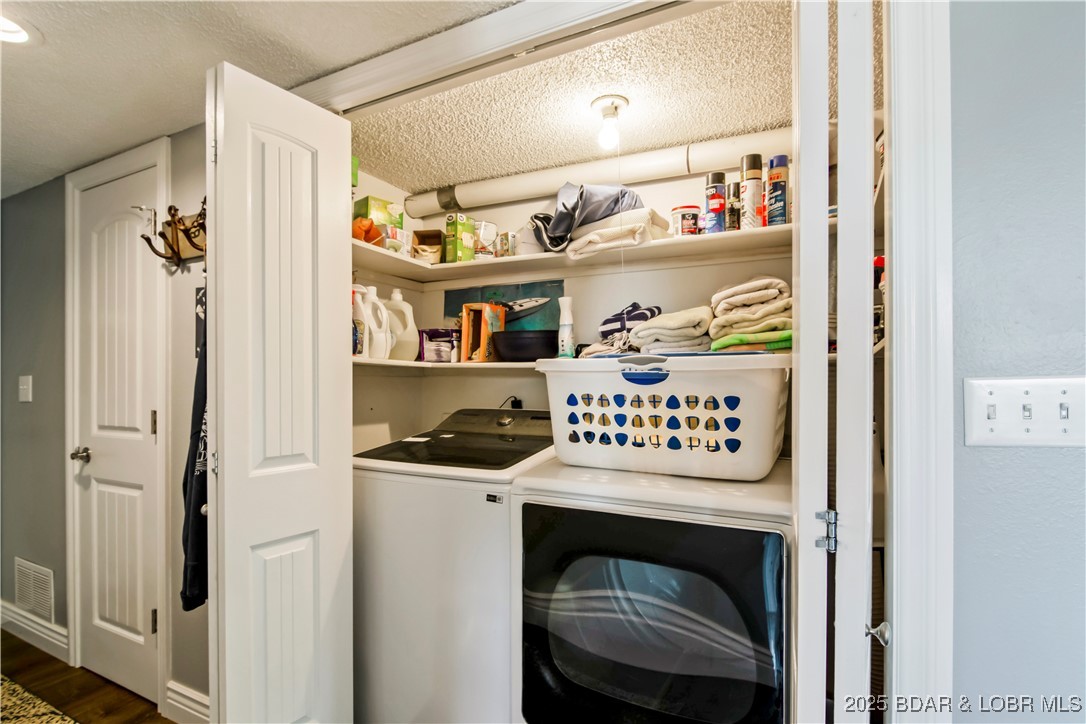889 Malibu Road, Unit 63 Osage Beach, MO 65065 - Photo 18 of 47 Newer washer and dryer are tucked away in the entr