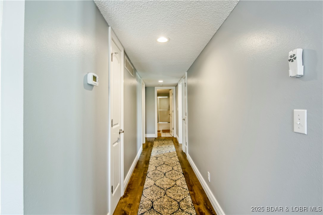 889 Malibu Road, Unit 63 Osage Beach, MO 65065 - Photo 21 of 47 The long hallway leads to the 3 bedrooms.