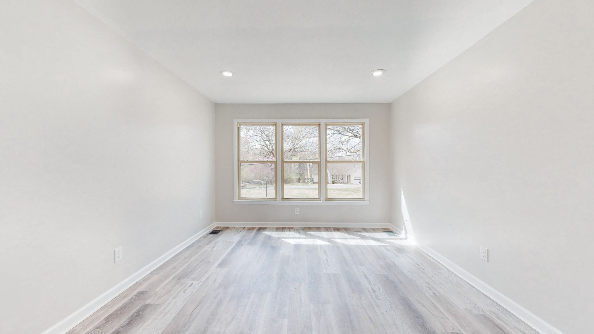 102 East Prospect Road Fayetteville, TN 37334 - Photo 13 of 32 an empty room with wooden floor and windows
