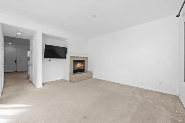 a view of an empty room with a fireplace