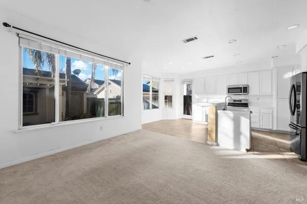 a view of kitchen with refrigerator and wooden floor