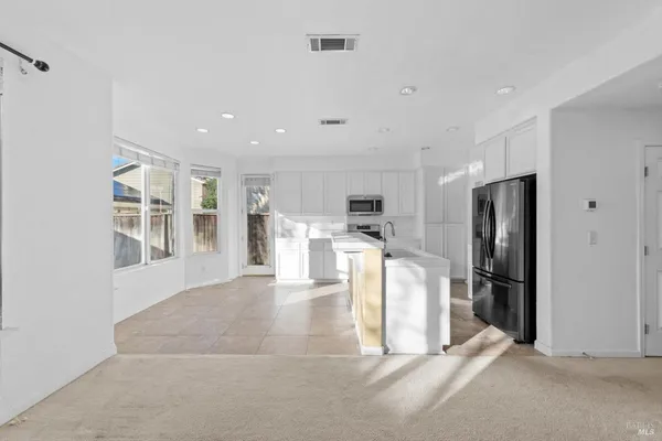 a large kitchen with cabinets and stainless steel appliances