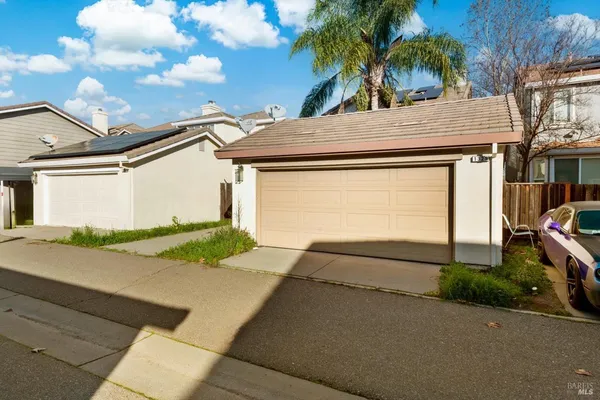 a view of a house with a yard and garage