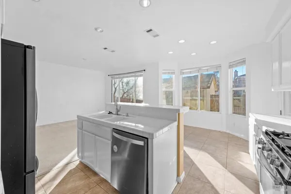a kitchen with stainless steel appliances granite countertop a sink stove and microwave