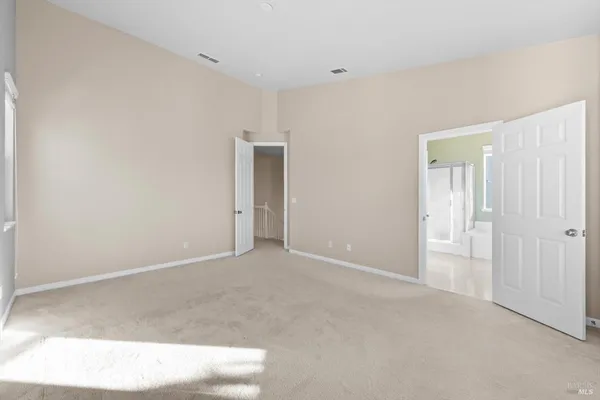 a bathroom with a tub a double vanity sink and a mirror