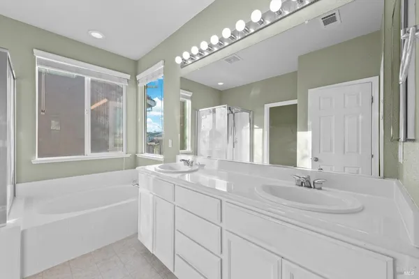 a bathroom with a tub shower and a sink