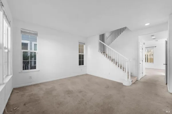a view of an empty room with stairs