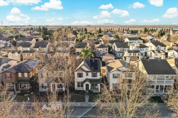 an aerial view of residential houses with outdoor space and ocean view