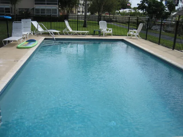 a view of a swimming pool with a lounge chair