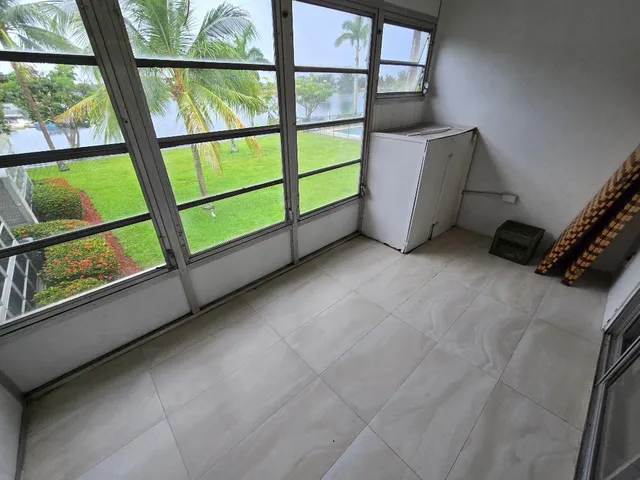 a view of a livingroom with furniture and a window