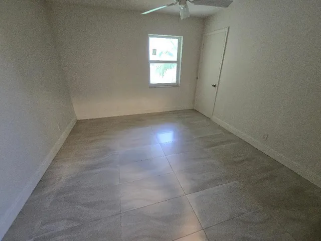 an empty room that has a window in it