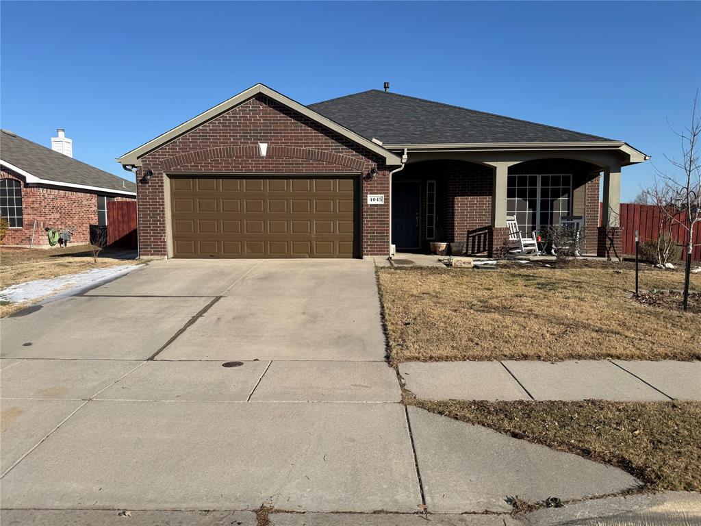 Single story home featuring a porch, brick siding, concrete driveway, an attached garage, and roof with shingles