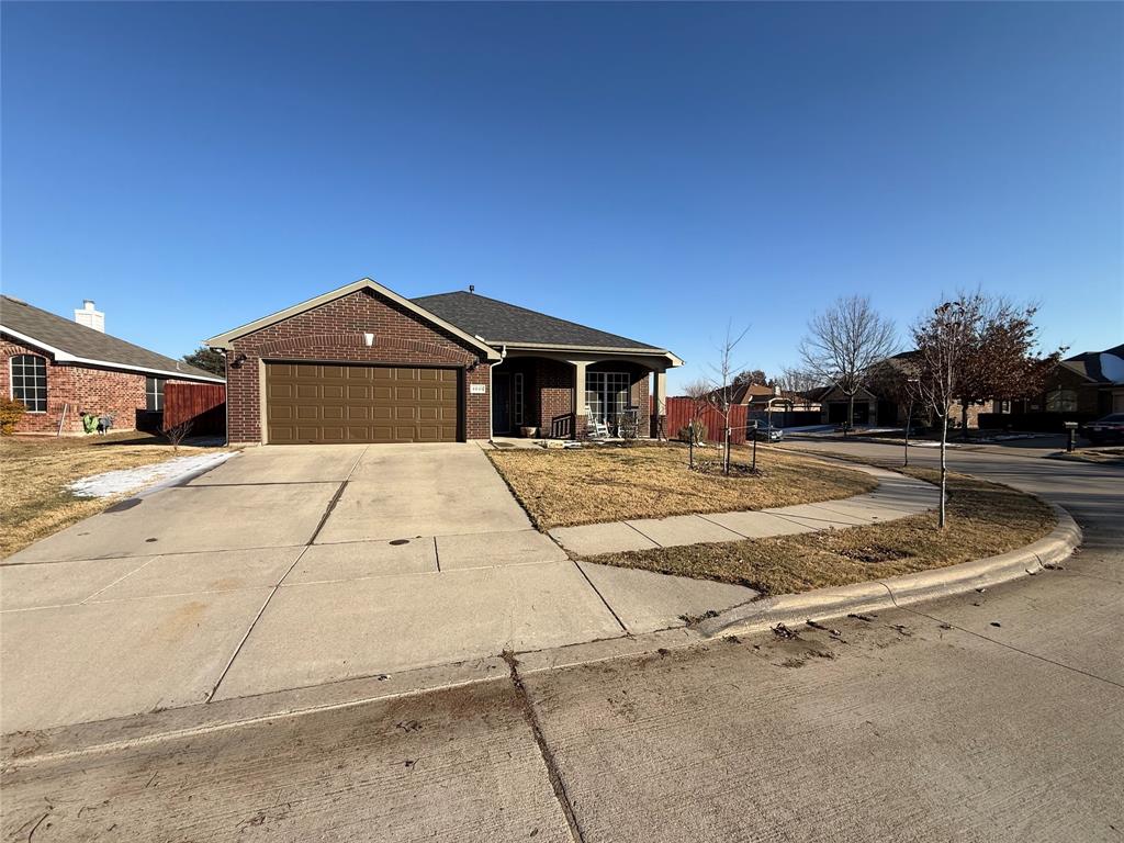 4045 Diamond Ridge Drive Fort Worth, TX 76244 - Photo 2 of 5 Ranch-style home with brick siding, concrete driveway, a porch, a garage, and a residential view