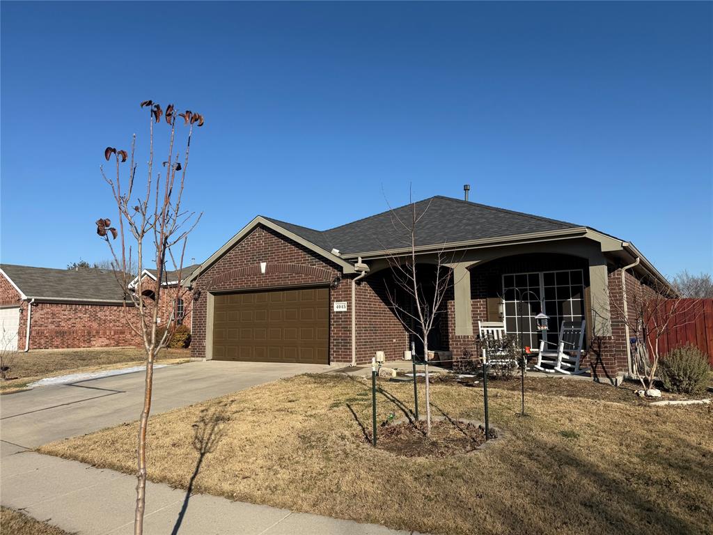 4045 Diamond Ridge Drive Fort Worth, TX 76244 - Photo 4 of 5 Single story home featuring concrete driveway, brick siding, a porch, a garage, and a front yard