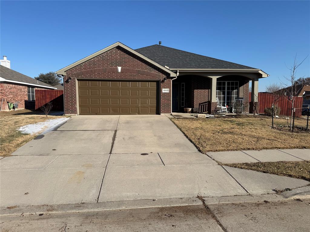 4045 Diamond Ridge Drive Fort Worth, TX 76244 - Photo 5 of 5 Single story home with concrete driveway, brick siding, a porch, and a garage