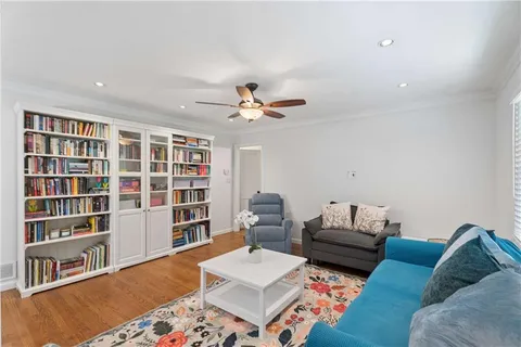 a living room with furniture and a book shelf