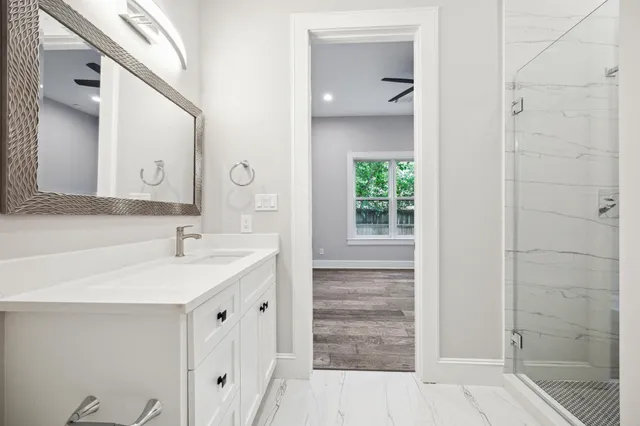 a bathroom with a toilet sink vanity and mirror
