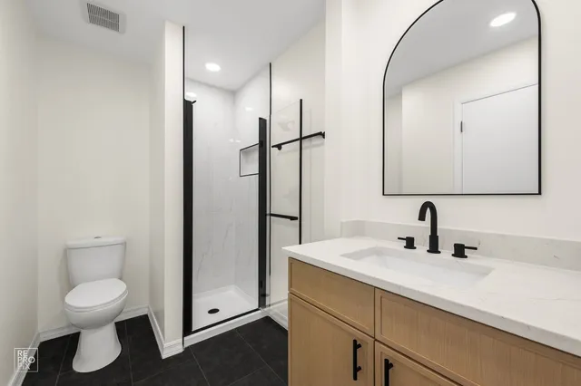 a bathroom with a sink a toilet and a mirror