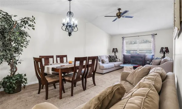 a living room with furniture wooden floor and a chandelier