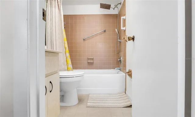 a bathroom with a granite countertop toilet and a shower