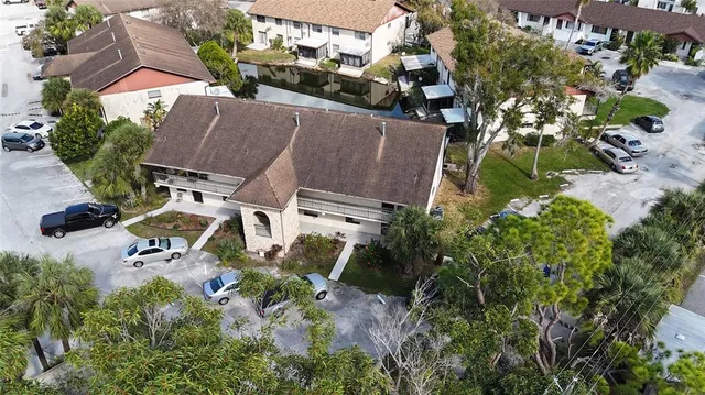 an aerial view of a house with a yard and street